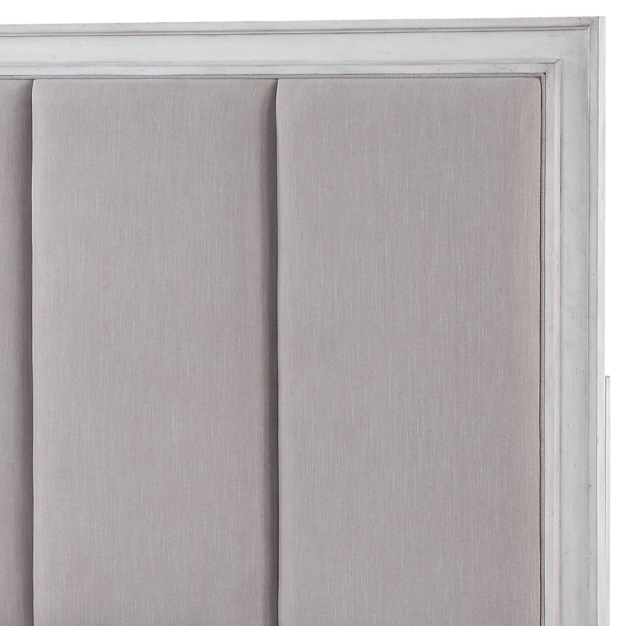 Upholstered headboard in light grey linen fabric with vertical channel tufting and distressed white wood frame