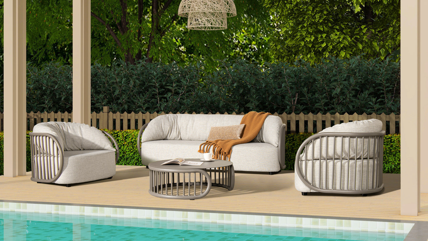 Light grey upholstered outdoor sofa with a grey metal frame and a tan throw blanket draped over it