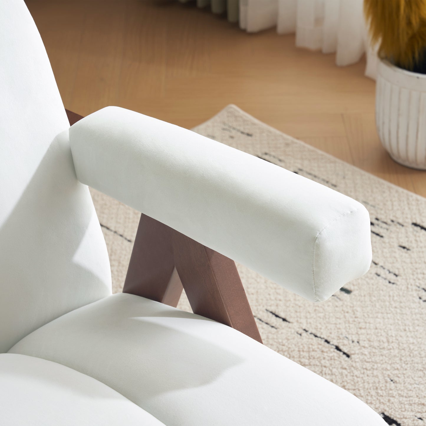 White velvet armchair armrest with dark wood frame soft texture
