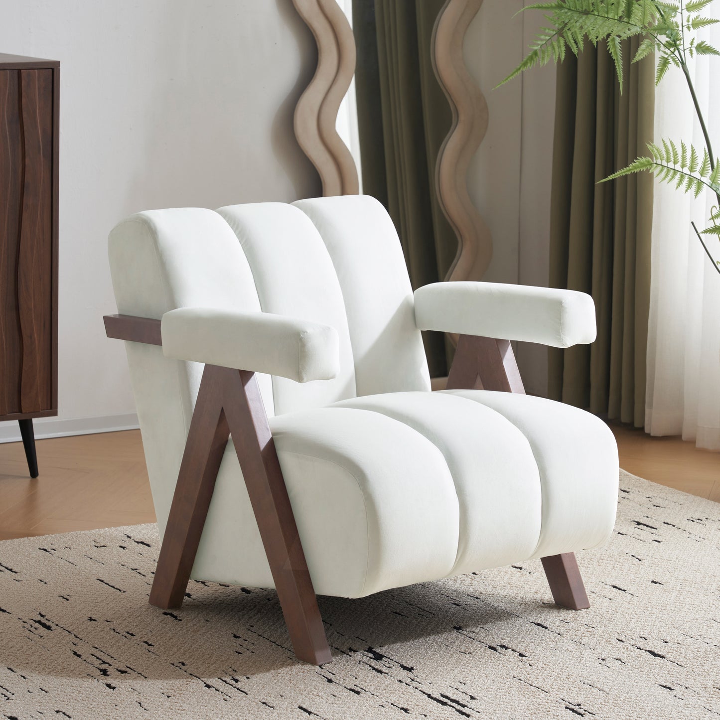 Plush white velvet armchair with channeled back and armrests featuring dark wood legs and accents