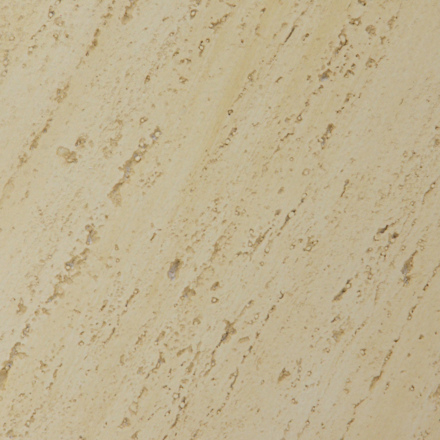 Textured beige travertine stone slab with natural variations