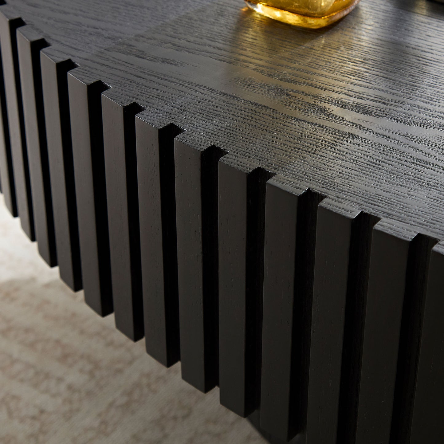Black oak wood coffee table with vertical fluted detailing and textured surface