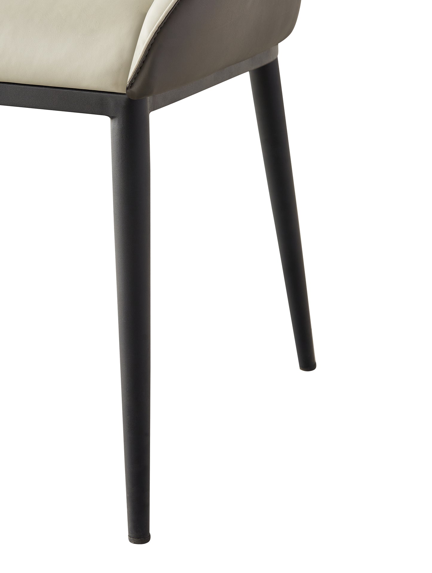 Closeup of a modern dining chair with cream leather seat and dark grey metal legs