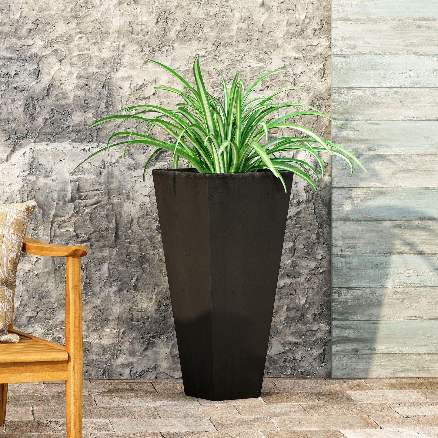 Tall black modern planter with a spider plant