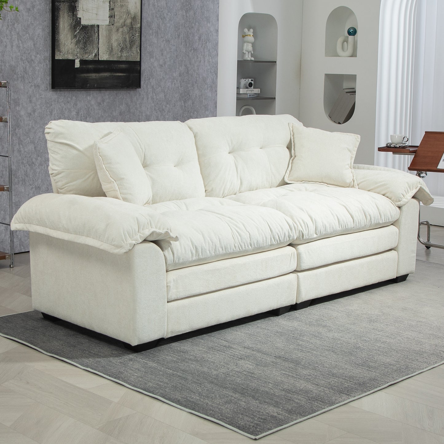 Plush cream white fabric sofa with deep tufted cushions and extra throw pillows perfect for living rooms