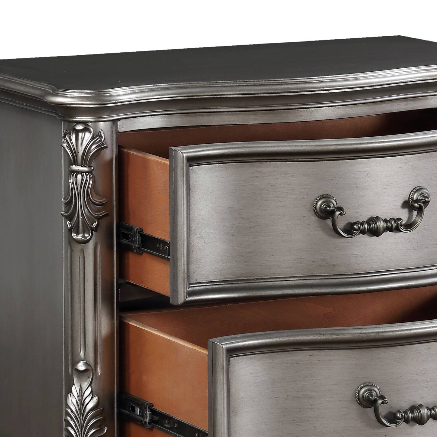 Antique silver dresser with ornate handles and carved details on drawers