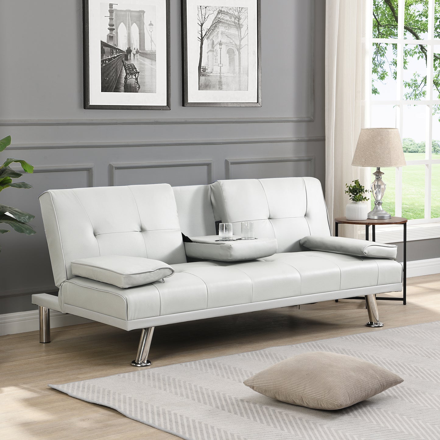 White faux leather convertible sofa with integrated cup holders and chrome legs