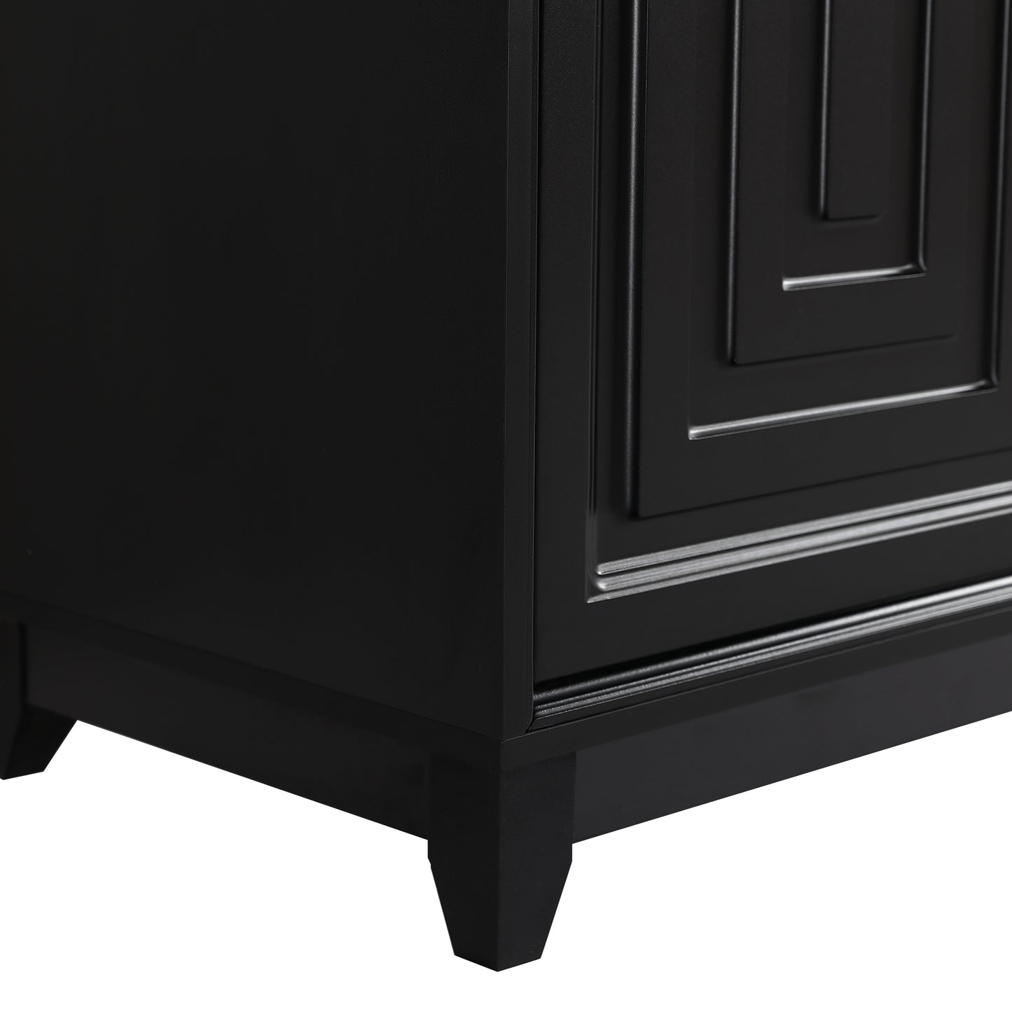Closeup of a modern black wooden dresser with geometric paneling and tapered legs