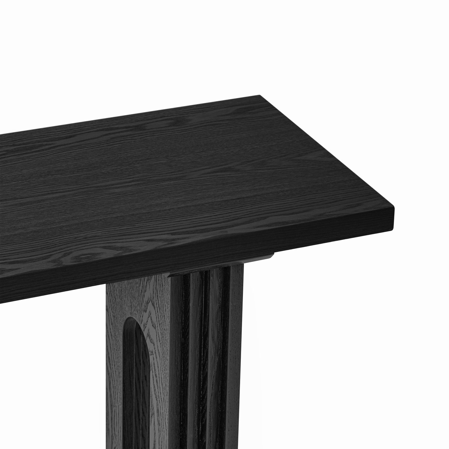 Closeup of black oak wood console table with fluted legs