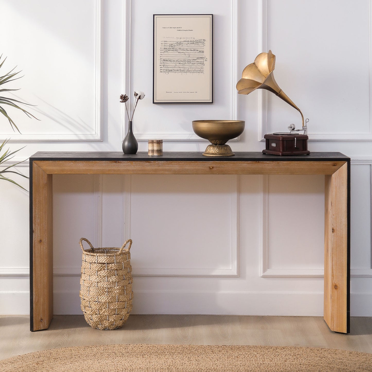 Rustic wood console table with black top featuring woven basket and antique gramophone
