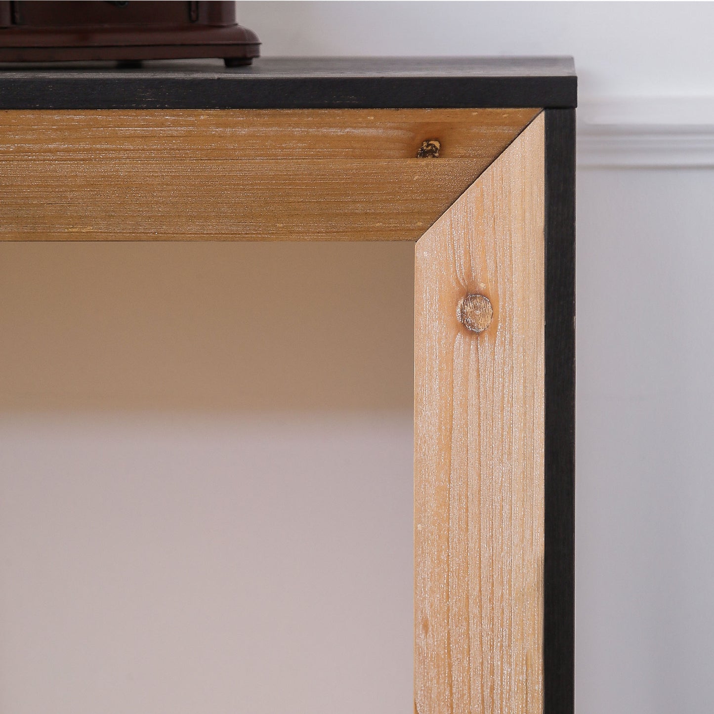 Rustic wood frame accent with black metal trim and visible knot detail