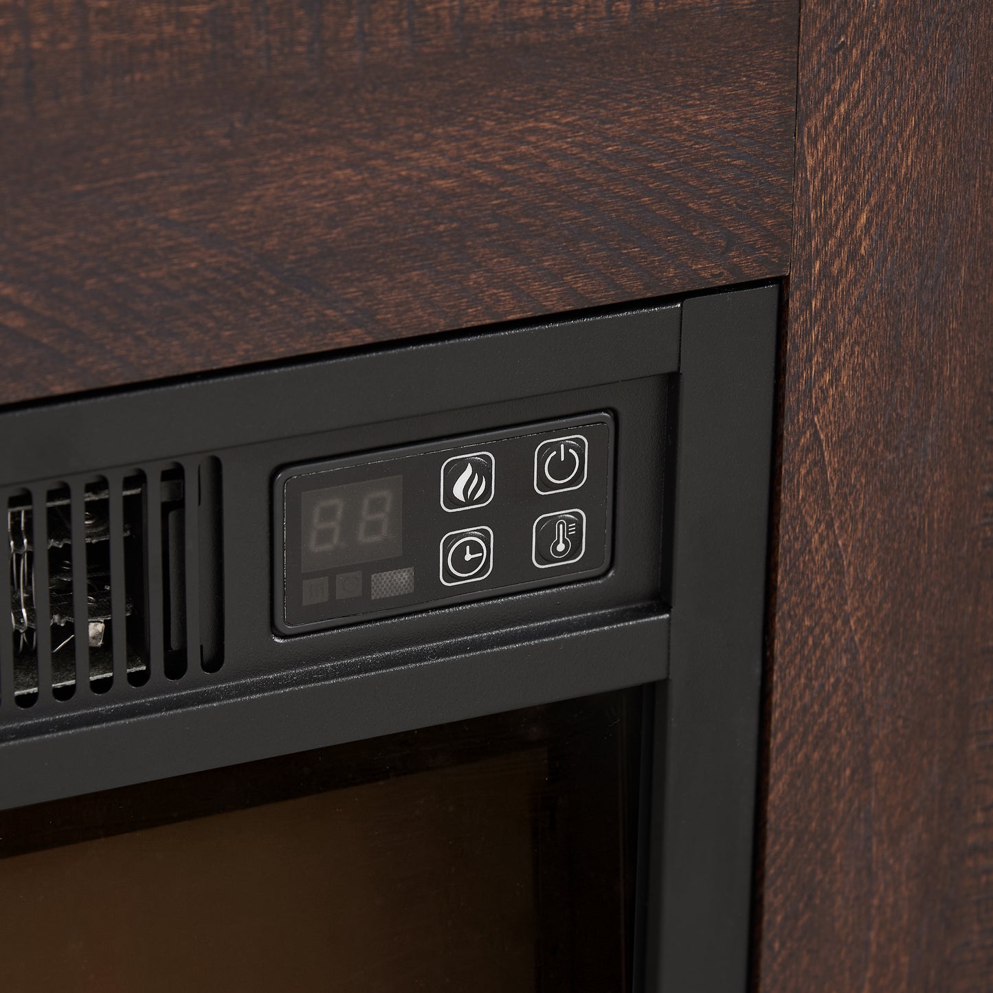 Closeup of electric fireplace control panel with digital display and icons for flame timer and temperature