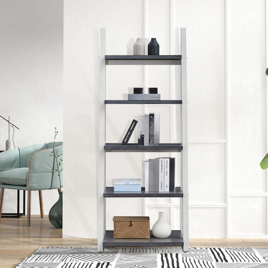 Modern ladder bookshelf with dark gray shelves and white frame holding books and decor
