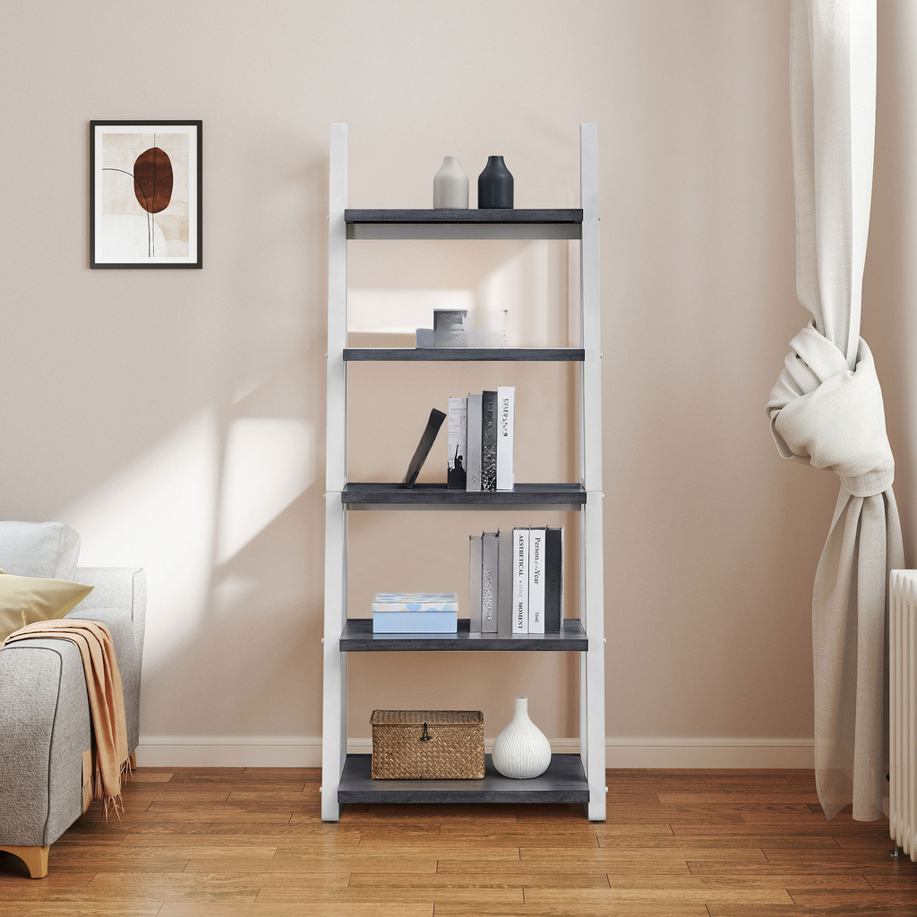 Modern ladder bookshelf with dark gray shelves and white frame displaying books and decor
