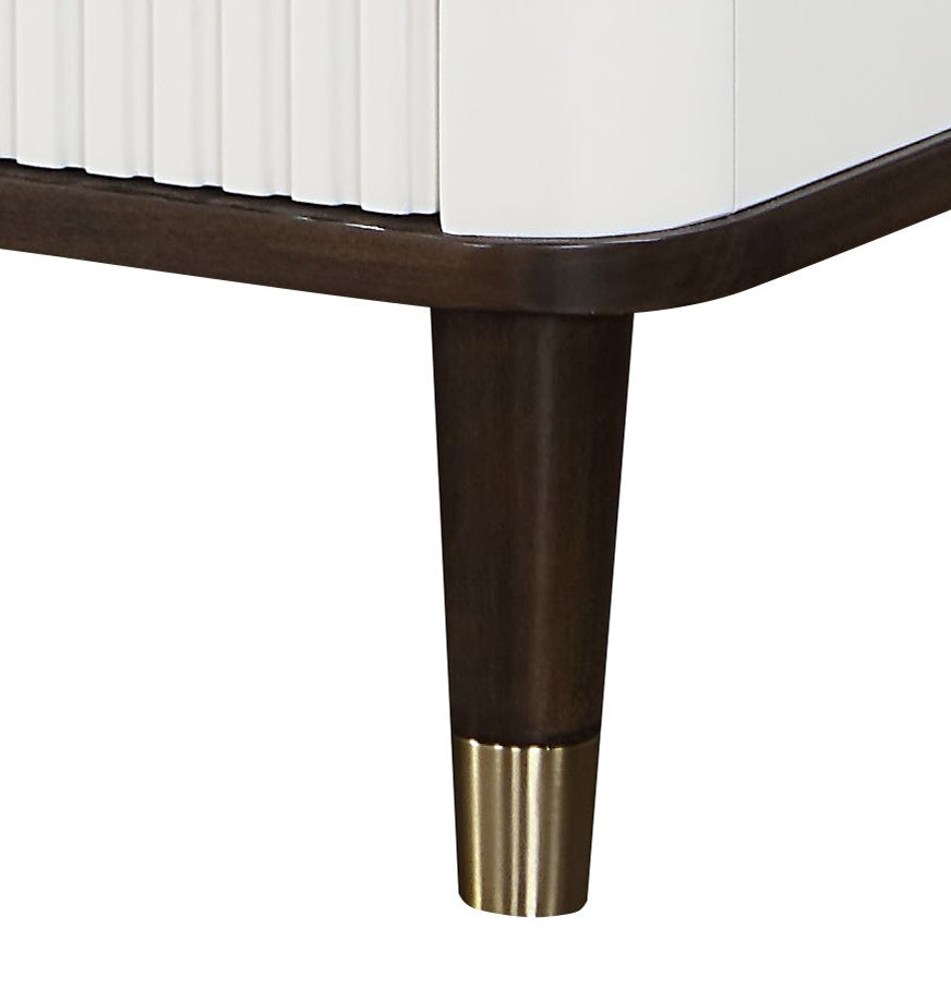 Modern white cabinet with fluted detail and tapered dark wood legs with brass accents