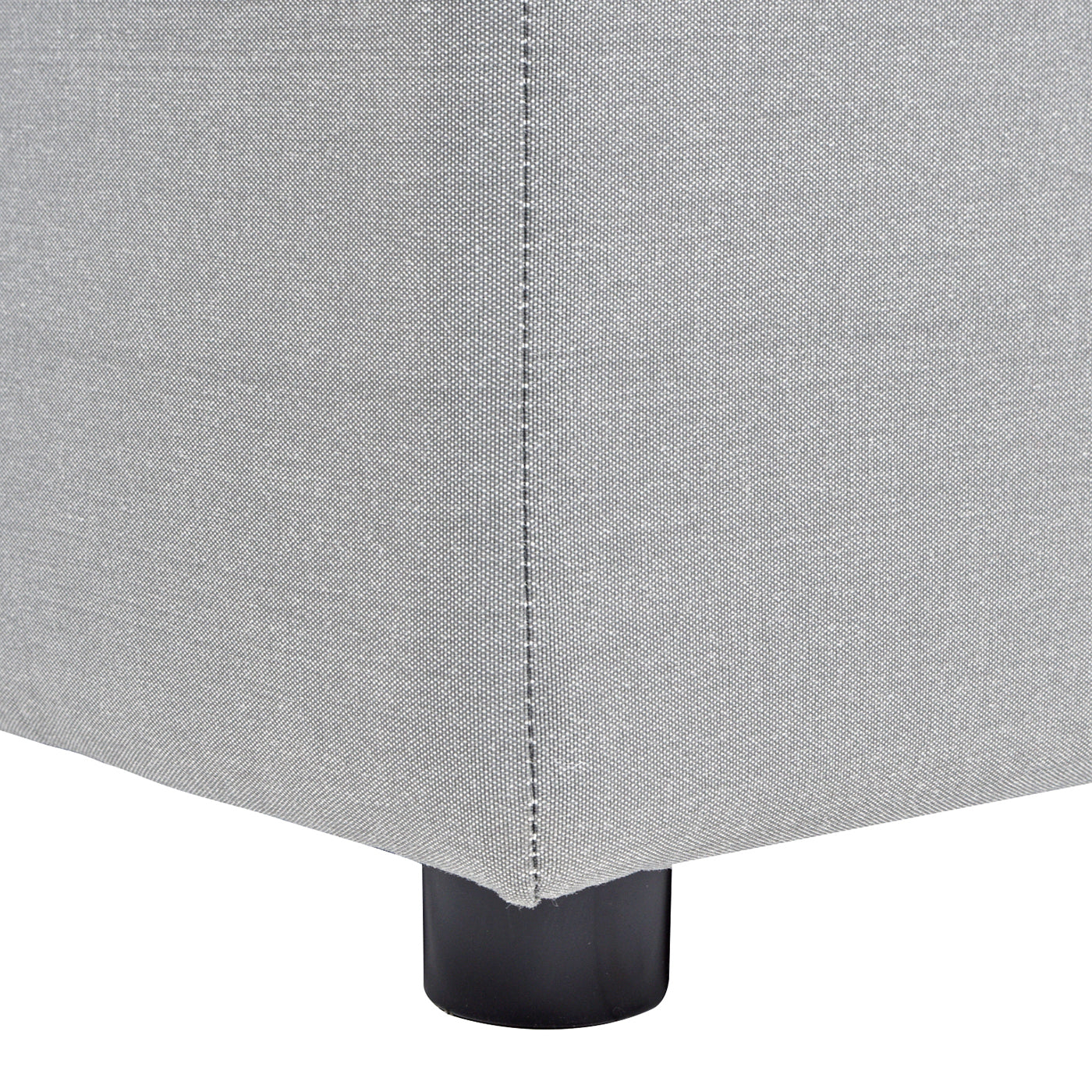 Light gray fabric ottoman base with black leg detail closeup view