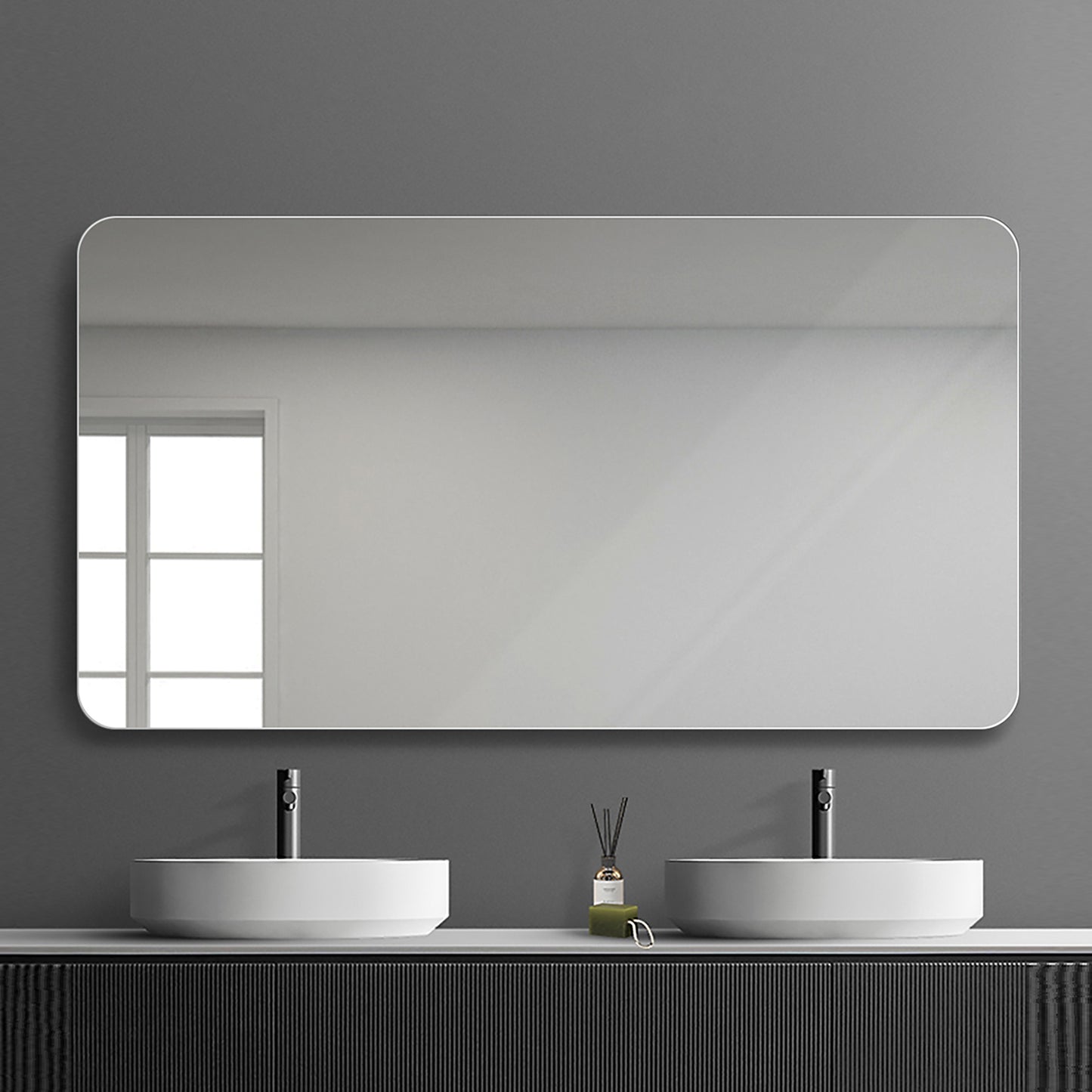 Large rounded rectangular bathroom mirror with sleek white frame mounted above double sinks