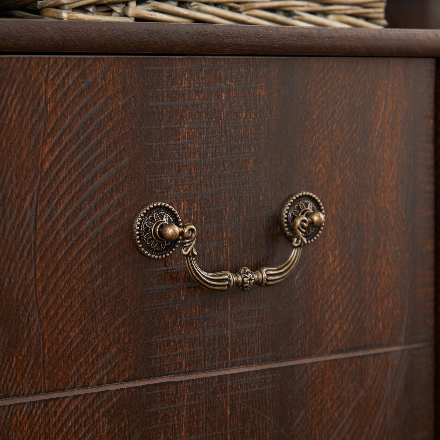 Dark oak dresser drawer with antique brass ornate pull handle