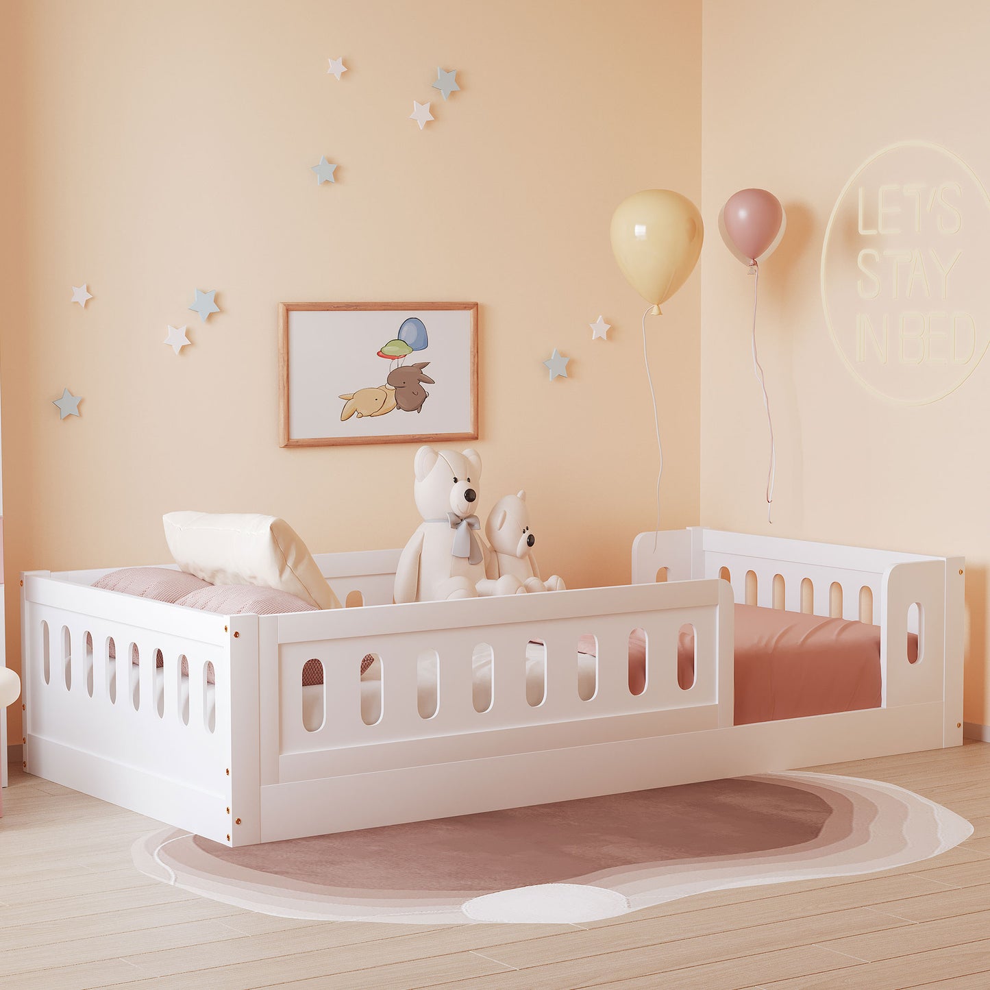 White toddler bed with safety rails and a pink fitted sheet
