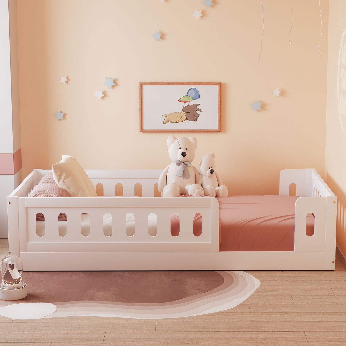 White toddler bed with guardrails and peach bedding featuring two teddy bears and wall art