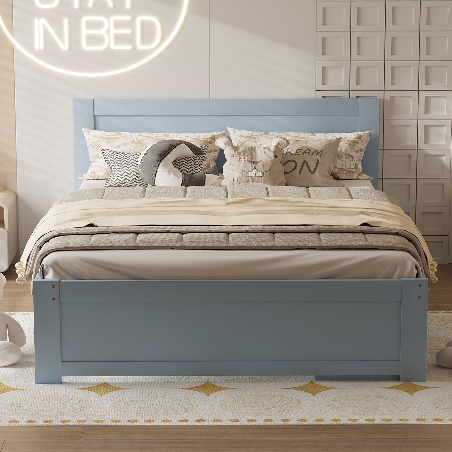 Blue wooden twin bed with patterned pillows and blankets in a childs bedroom