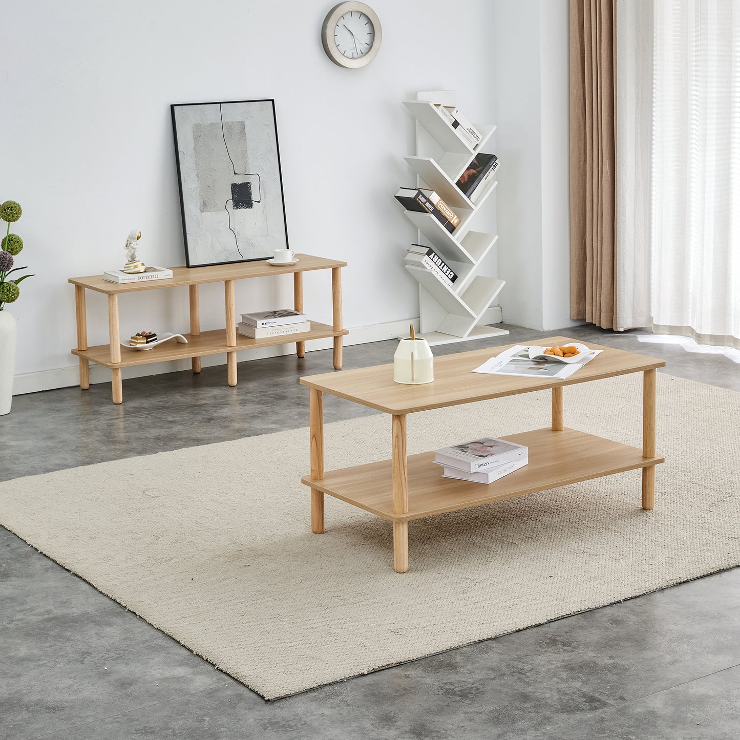 Modern light oak wood coffee table with a lower shelf featuring books and fruit
