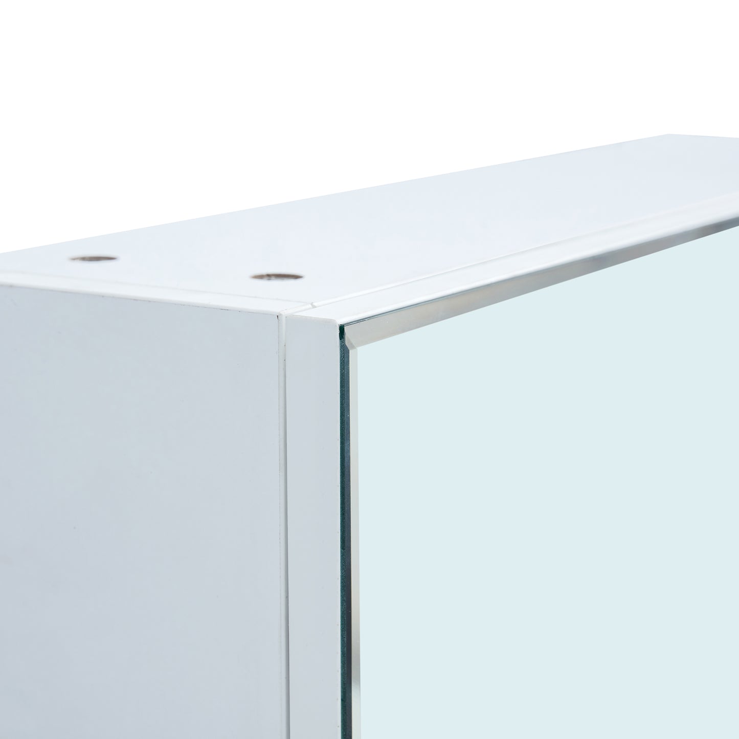 Closeup of a white MDF cabinet with a silver trim and a mirrored door panel
