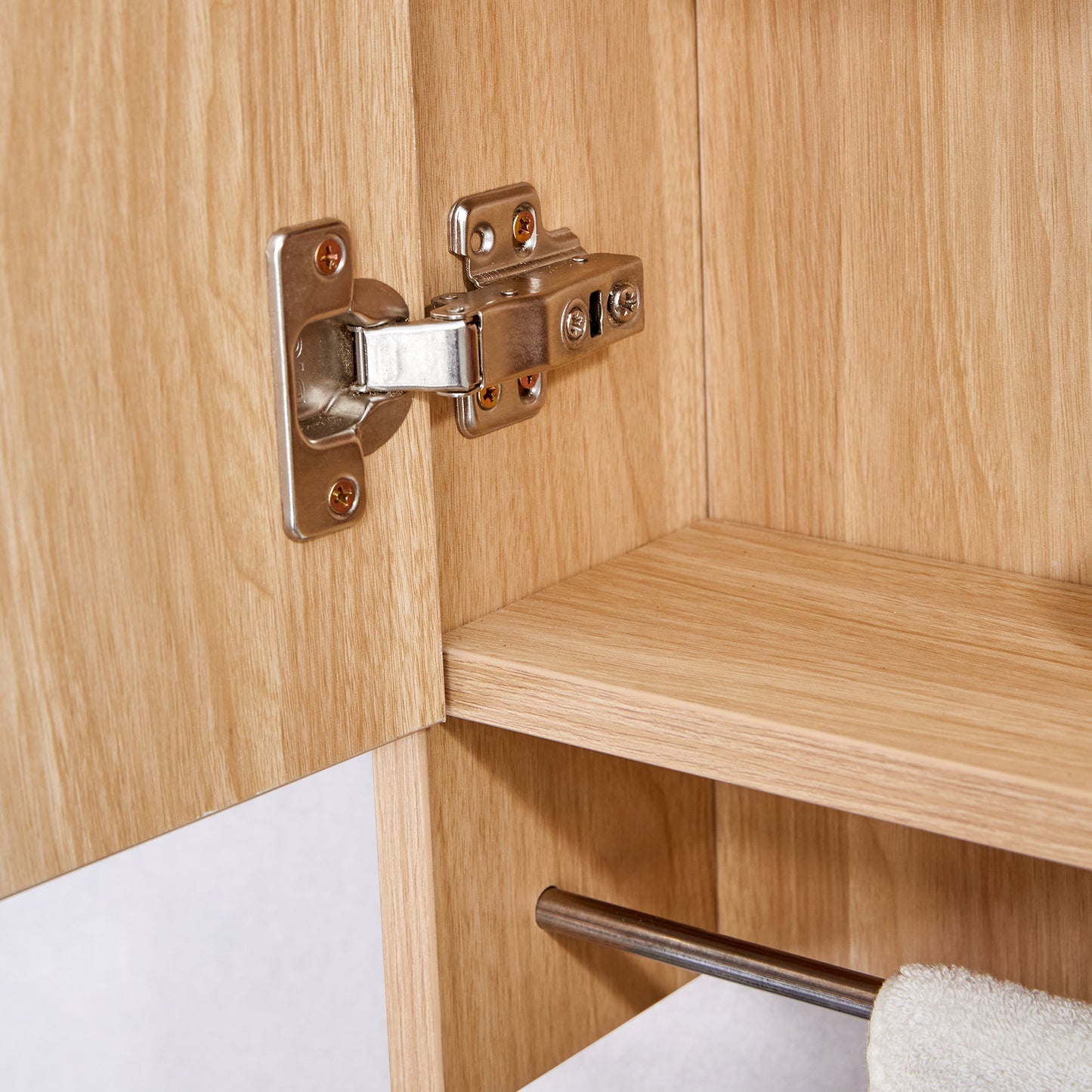 Metal cabinet hinge with wood grain texture background