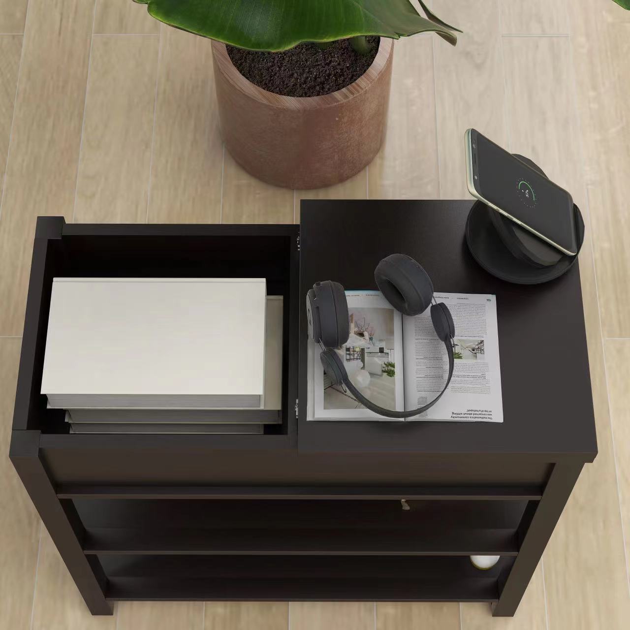 Dark espresso storage end table with open shelving holding books and magazines