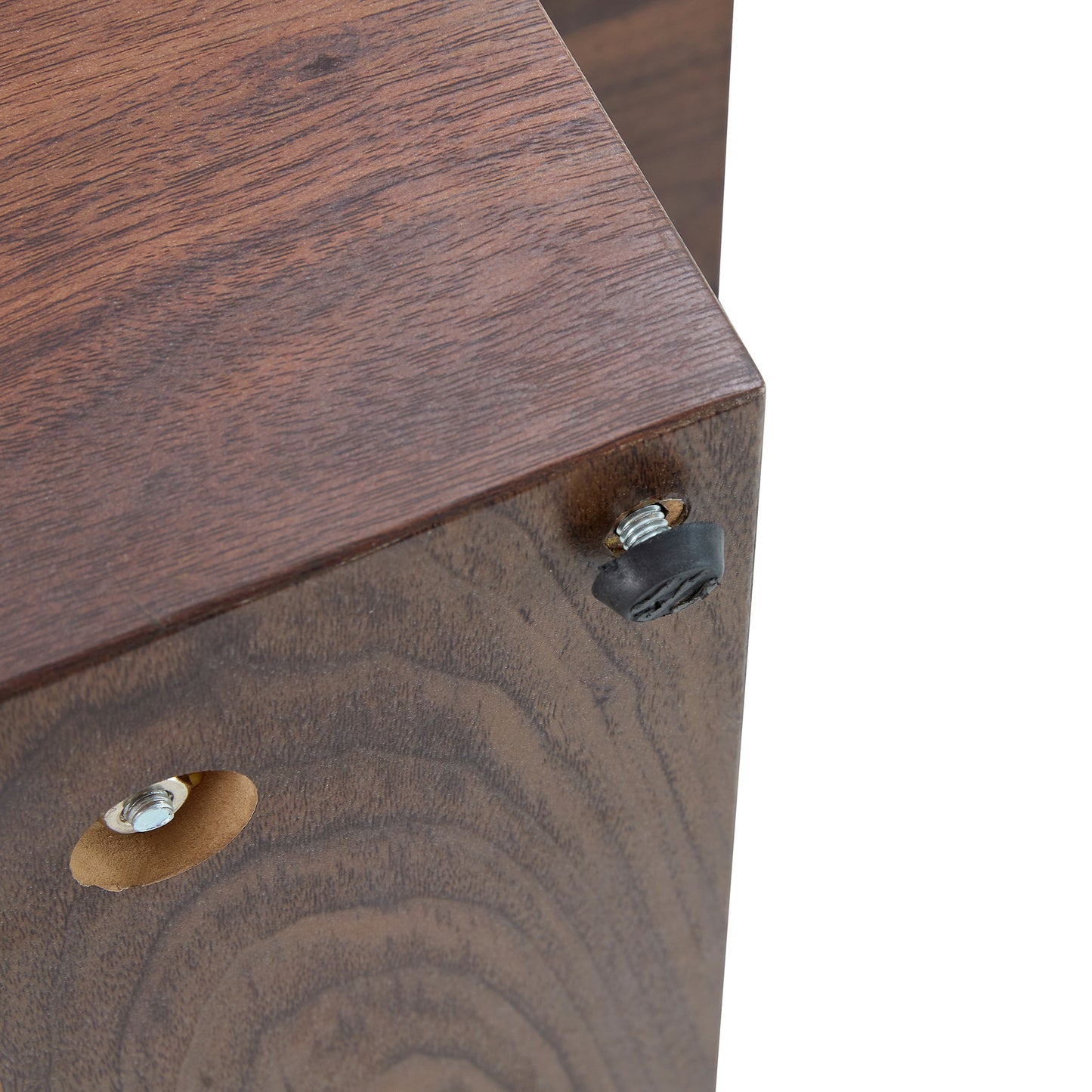 Dark wood veneer shelf corner with black rubber foot and metal screw