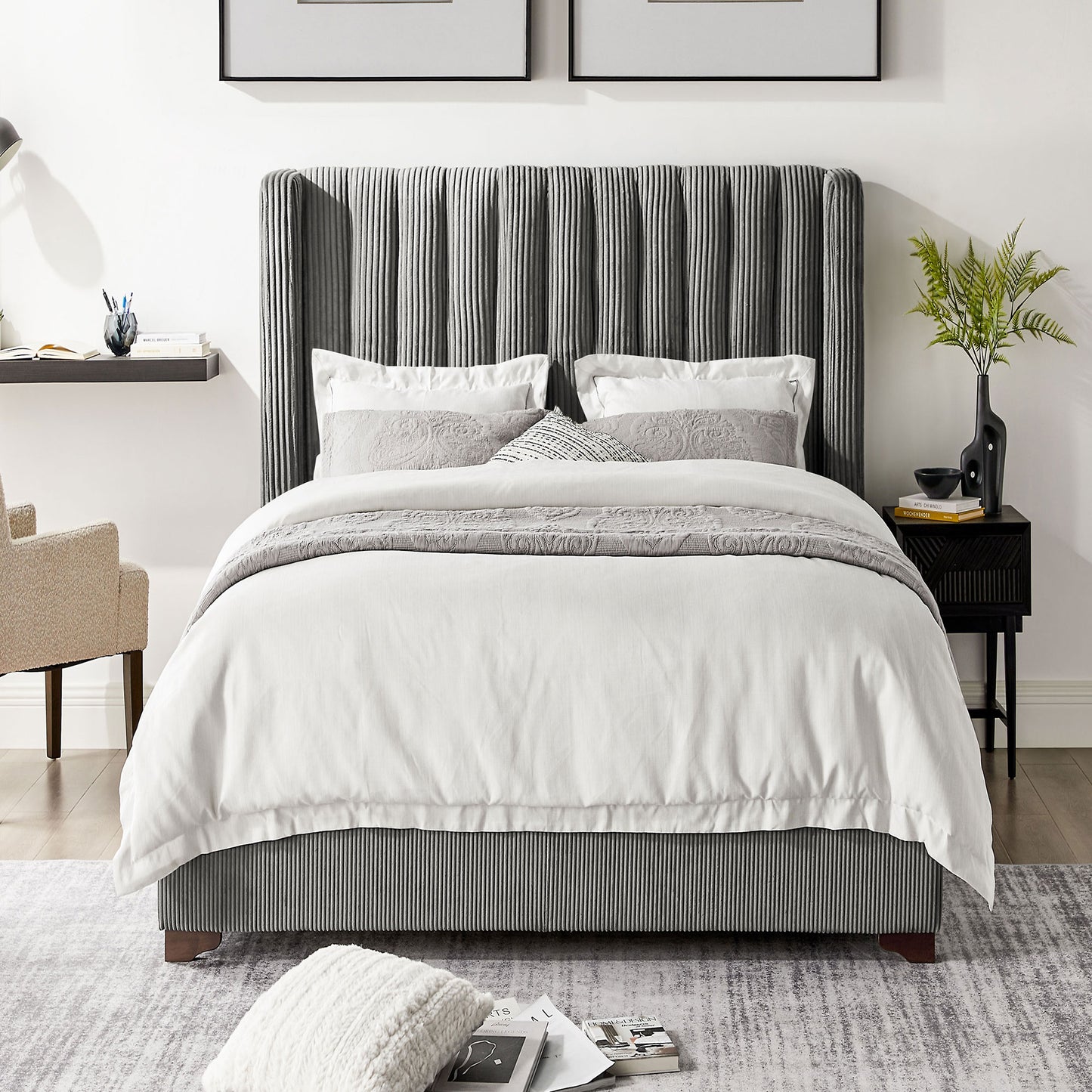 Plush grey velvet channel tufted headboard on a kingsize bed with white linens