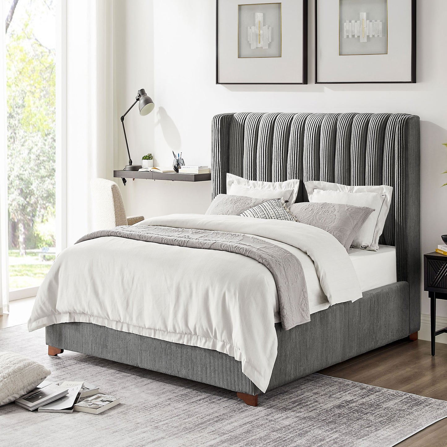 Upholstered king bed frame with vertical grey tufting on the headboard and striped base