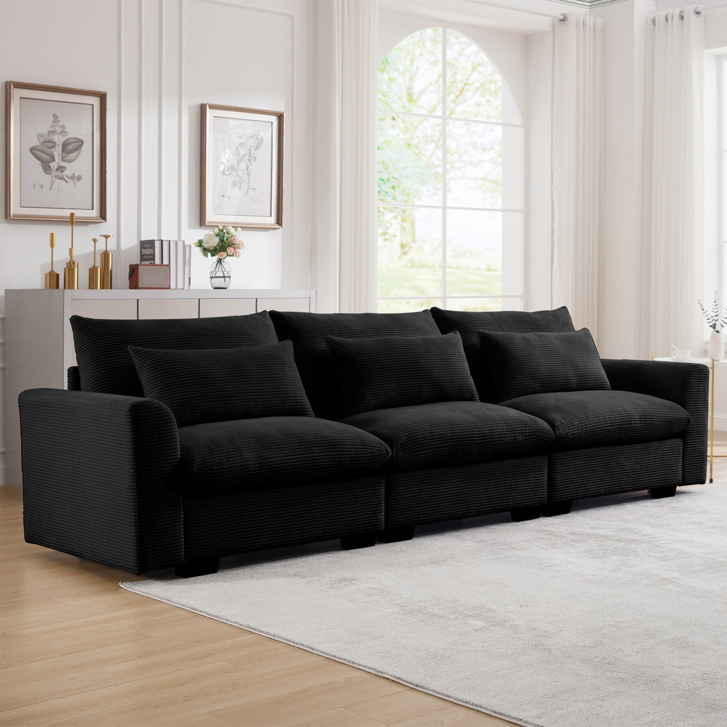 Plush black corduroy sectional sofa with deep seats and multiple throw pillows for ultimate comfort