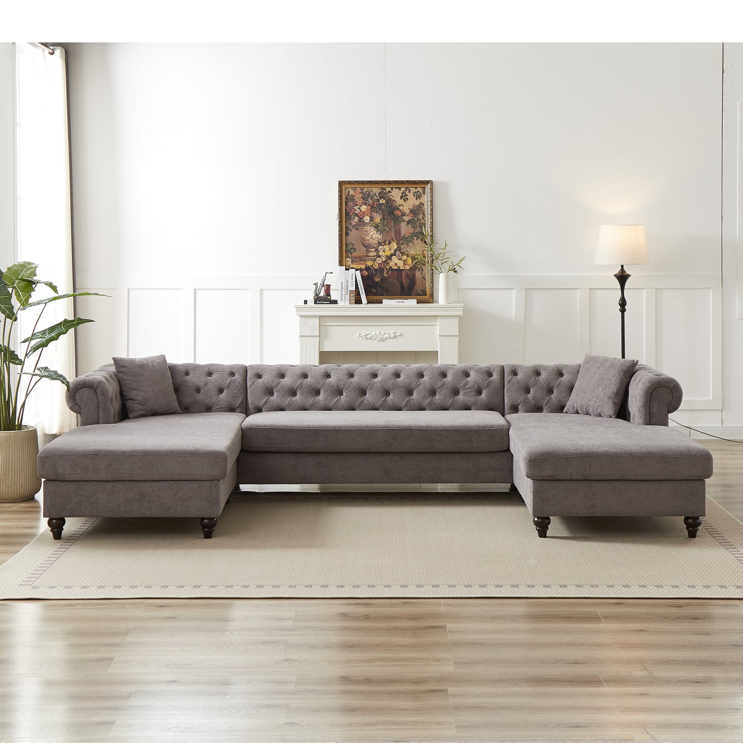 Gray tufted Ushaped sectional sofa with chaise lounge and accent pillows