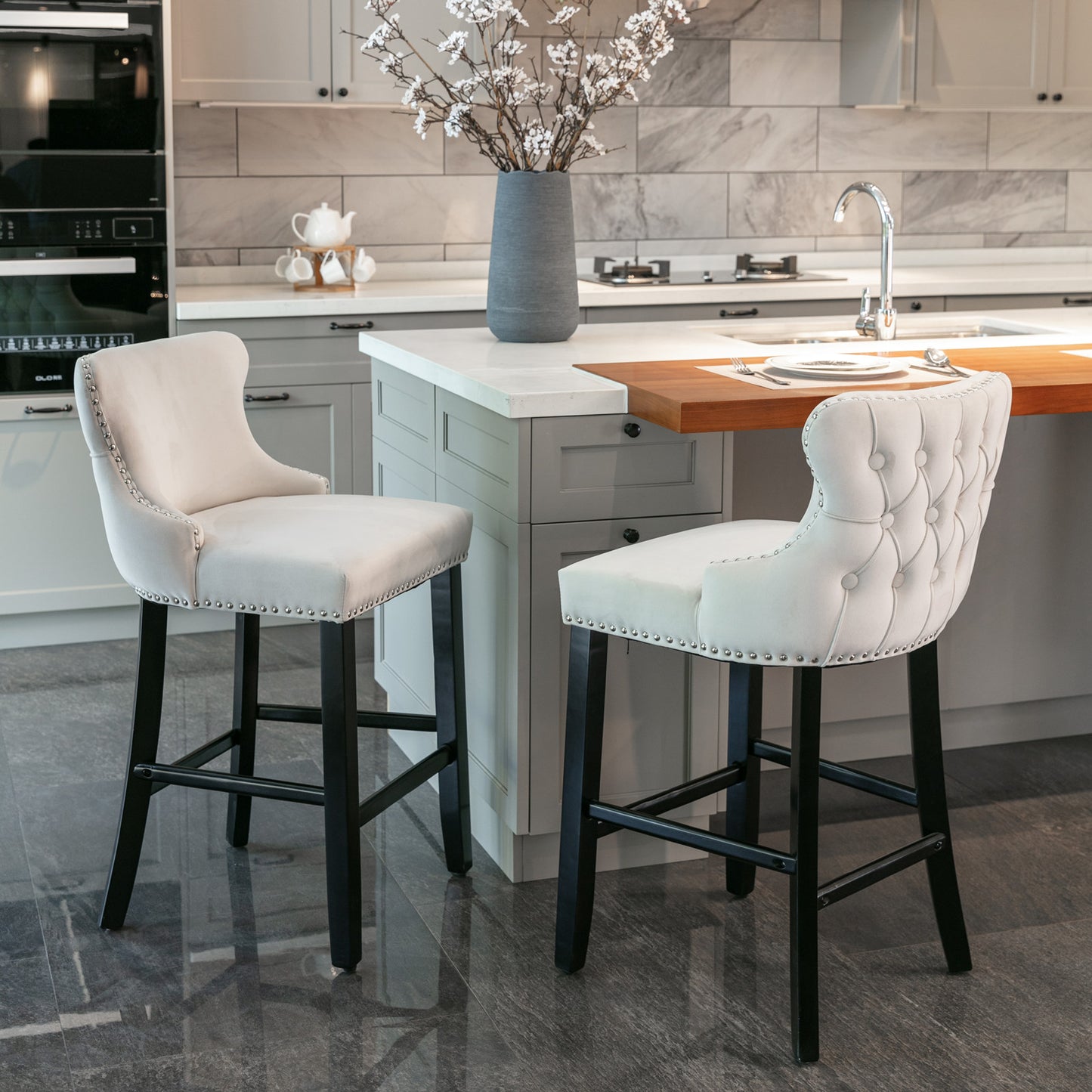 Tufted cream velvet bar stool with silver nailhead trim and dark wood legs