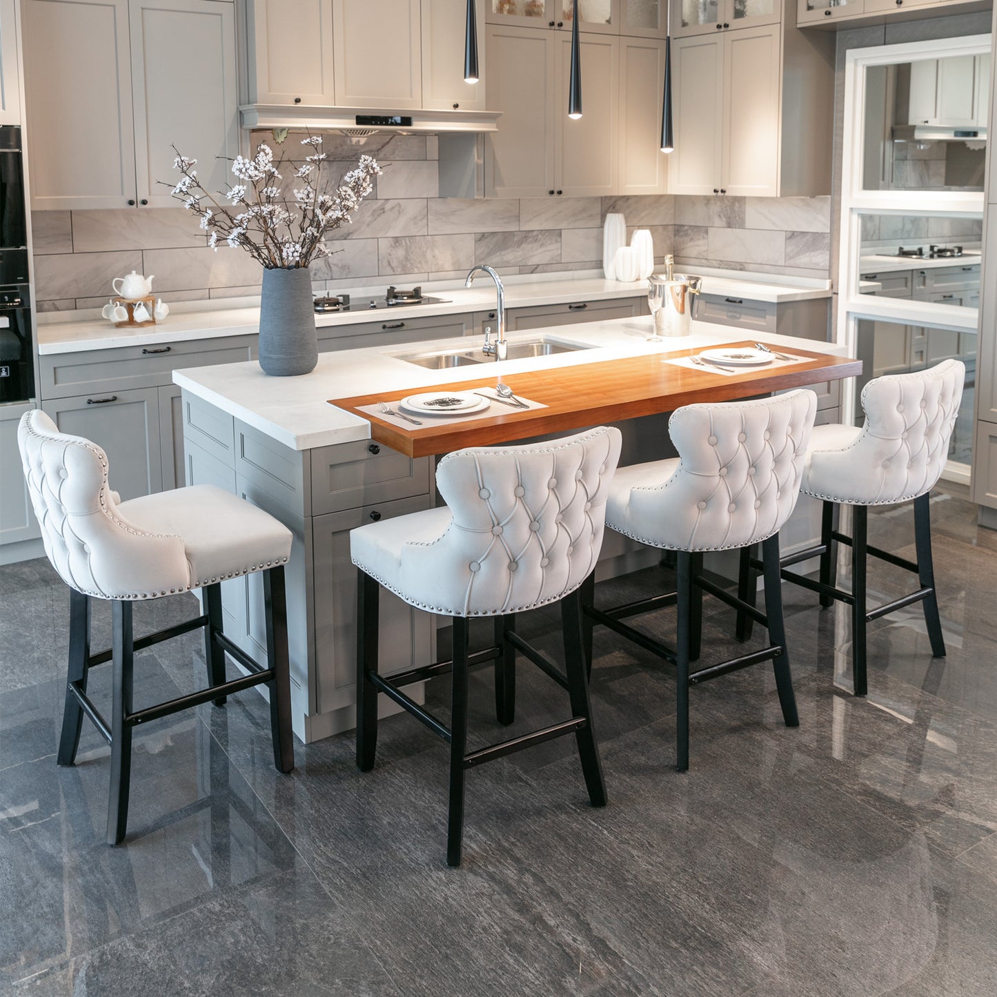 Tufted white velvet bar stool with silver nailhead trim and black legs