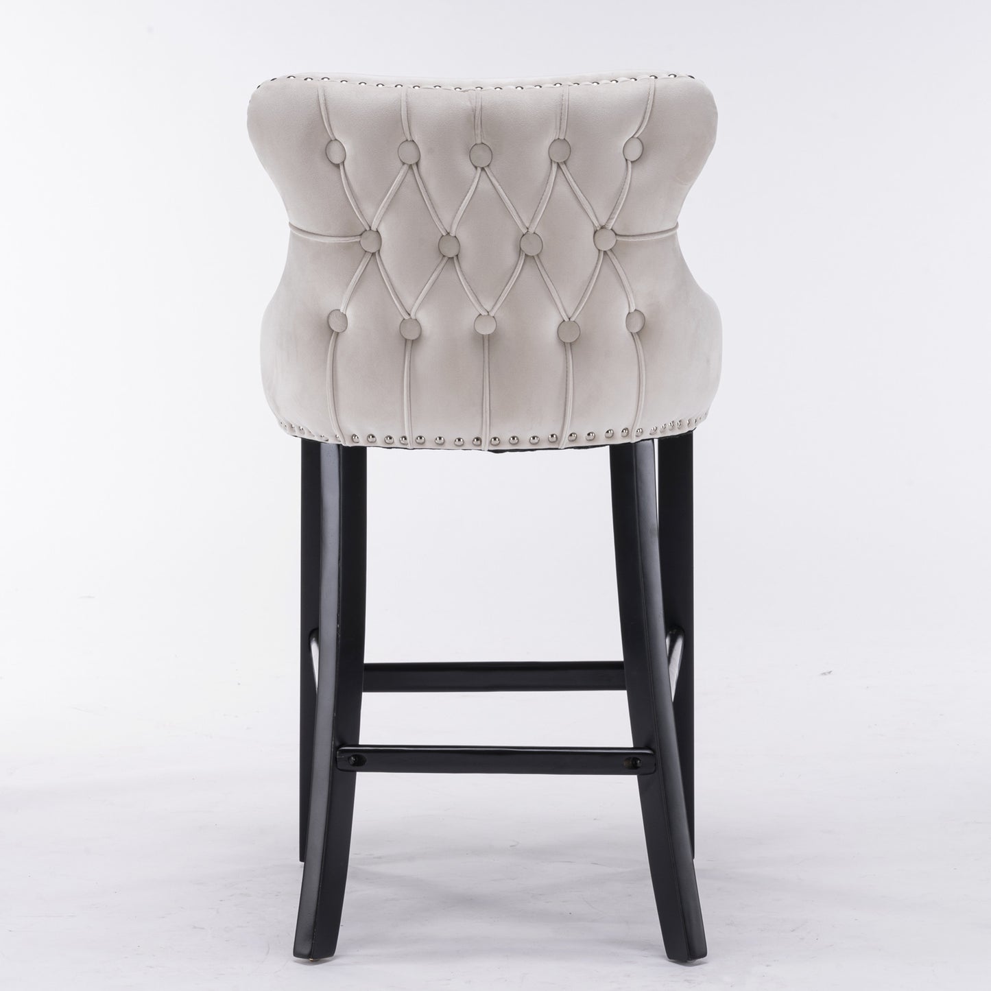 Light grey velvet tufted bar stool with silver nailhead trim and black legs