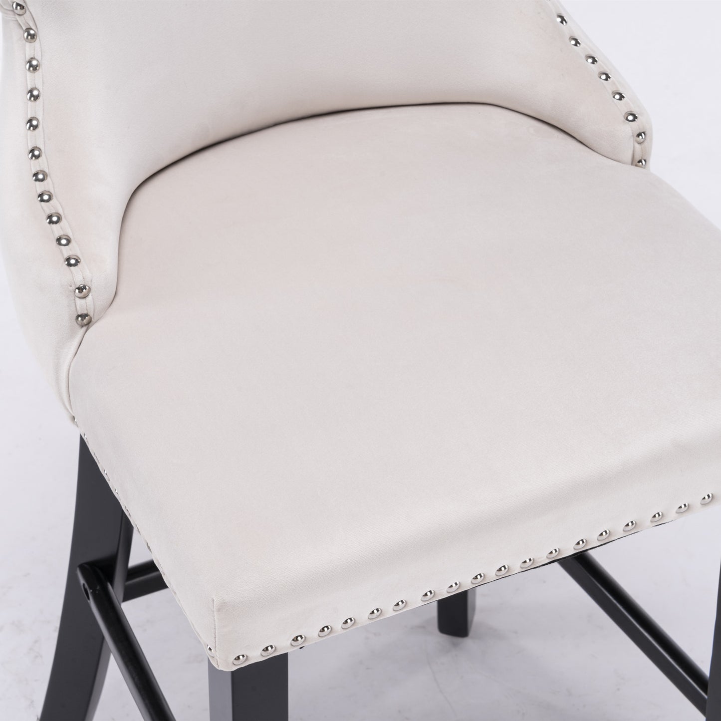 Cream velvet bar stool with decorative nailhead trim and dark wood legs