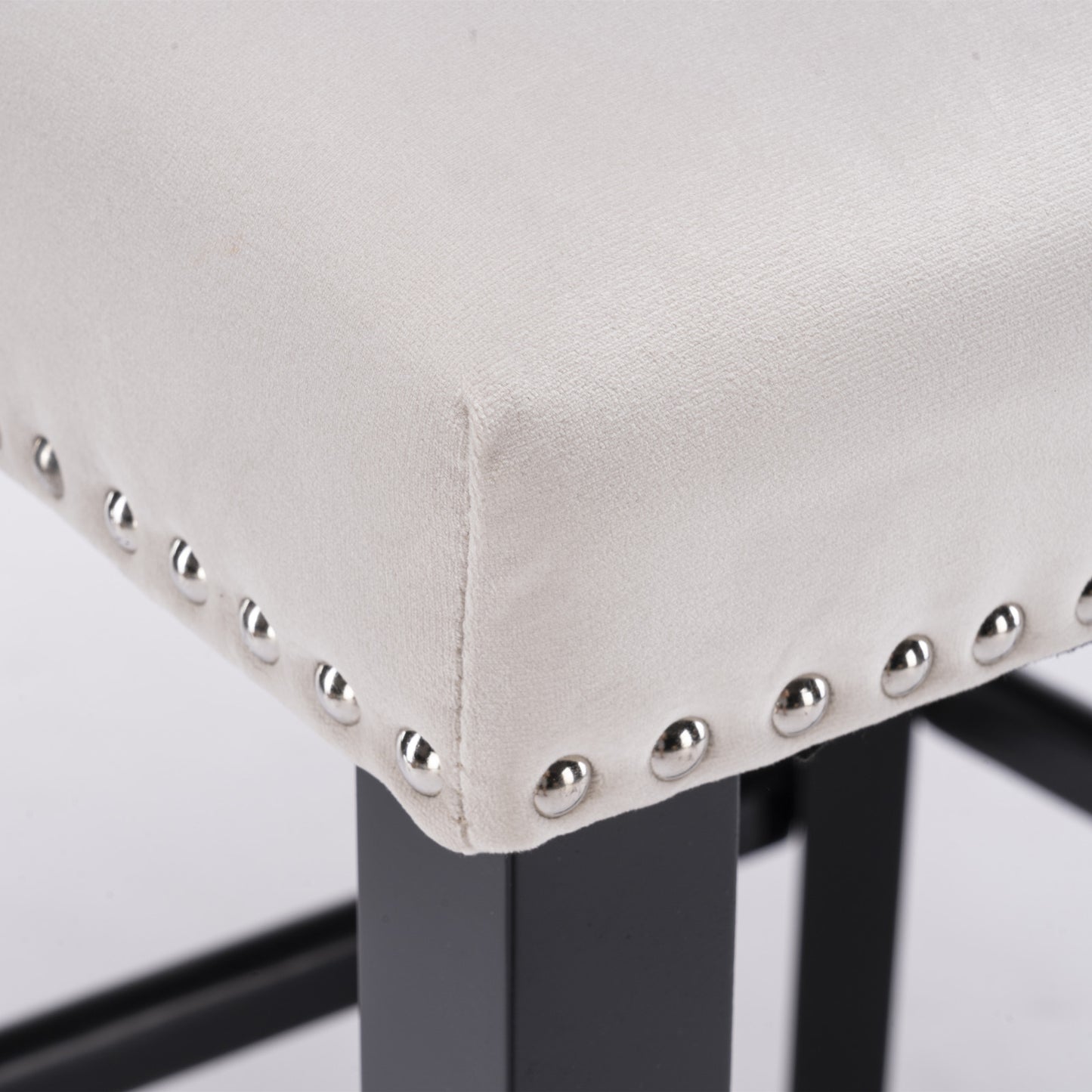 Cream velvet bar stool with silver nailhead trim and black wood legs