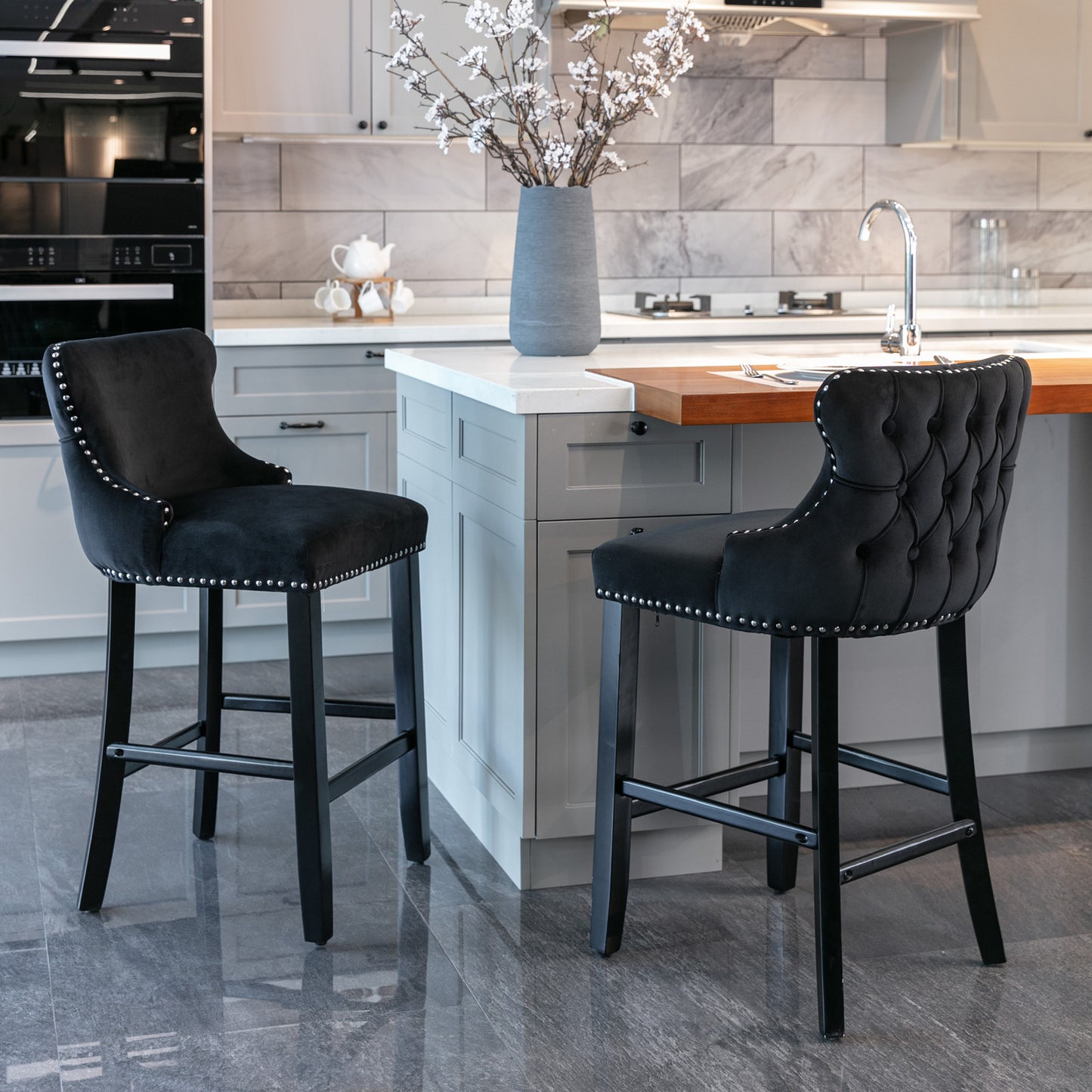 Black velvet bar stool with silver nailhead trim and tufted back