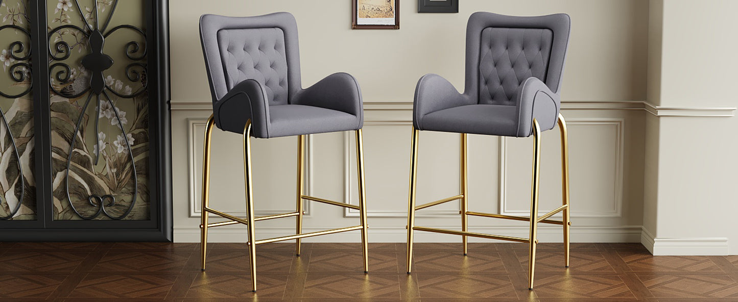 Tufted grey velvet bar stools with elegant gold legs perfect for modern kitchens