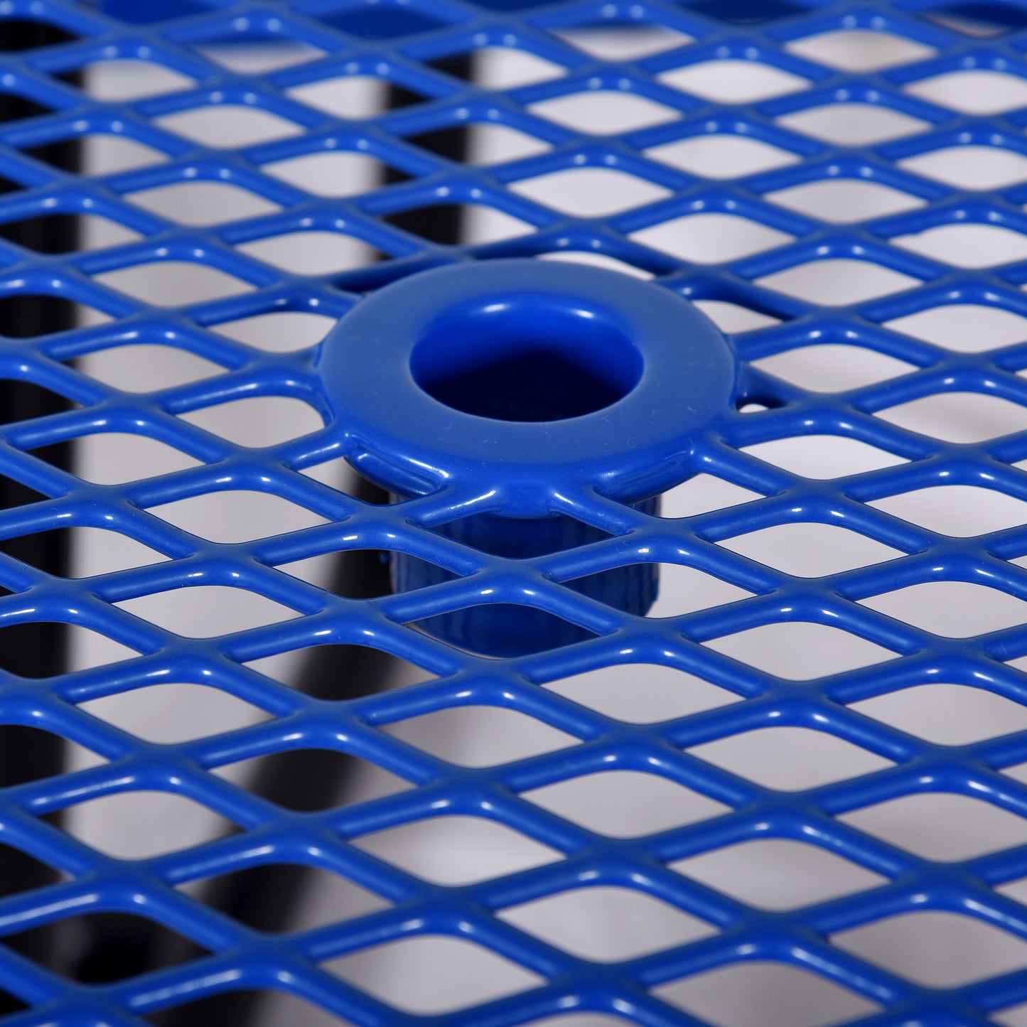 Closeup of a vibrant blue diamond mesh table surface with a central hole ideal for outdoor furniture