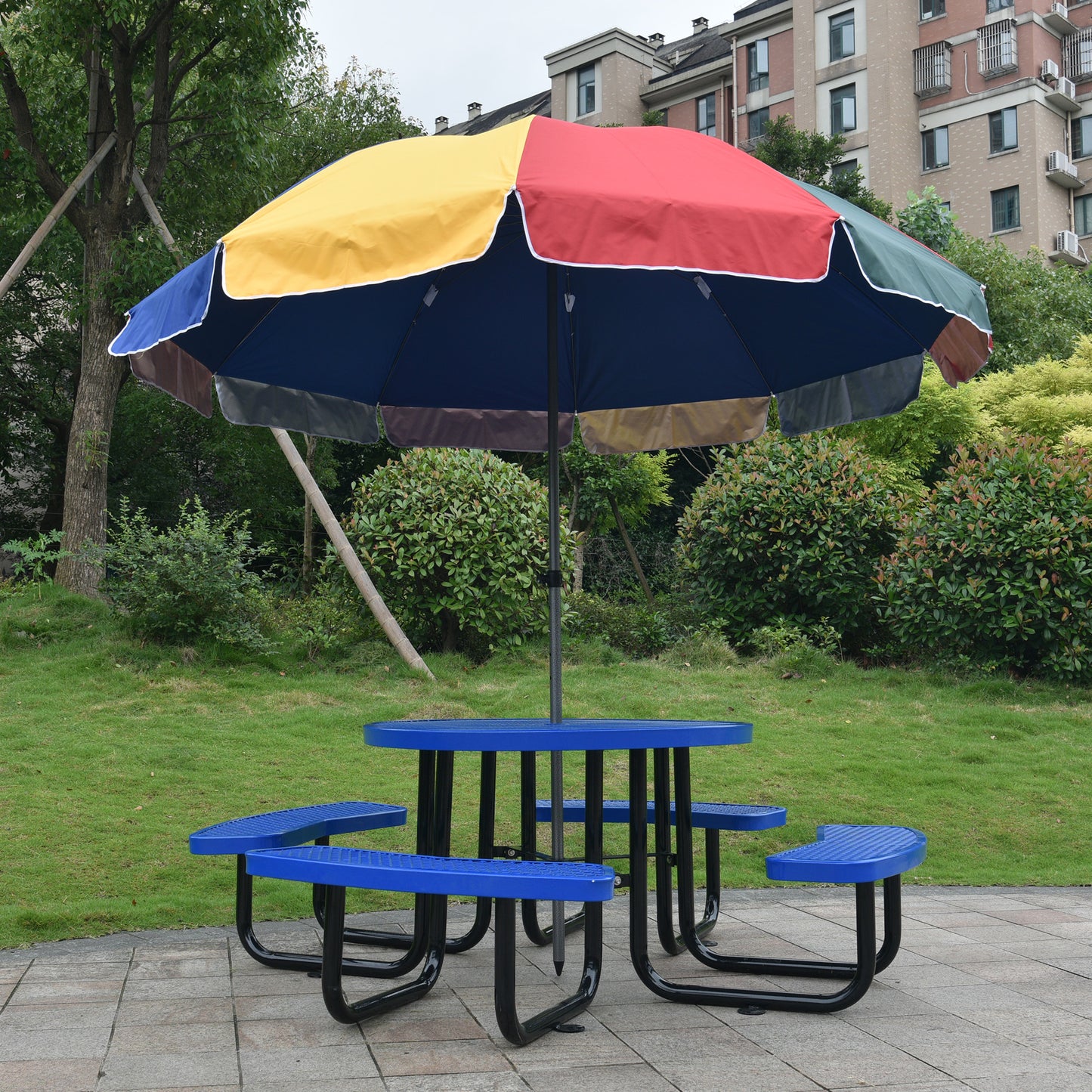 Multicolor picnic table umbrella providing shade for blue metal picnic table
