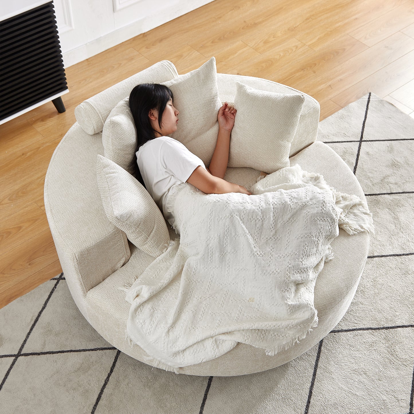 Circular cream textured sofa with plush cushions ideal for comfortable lounging