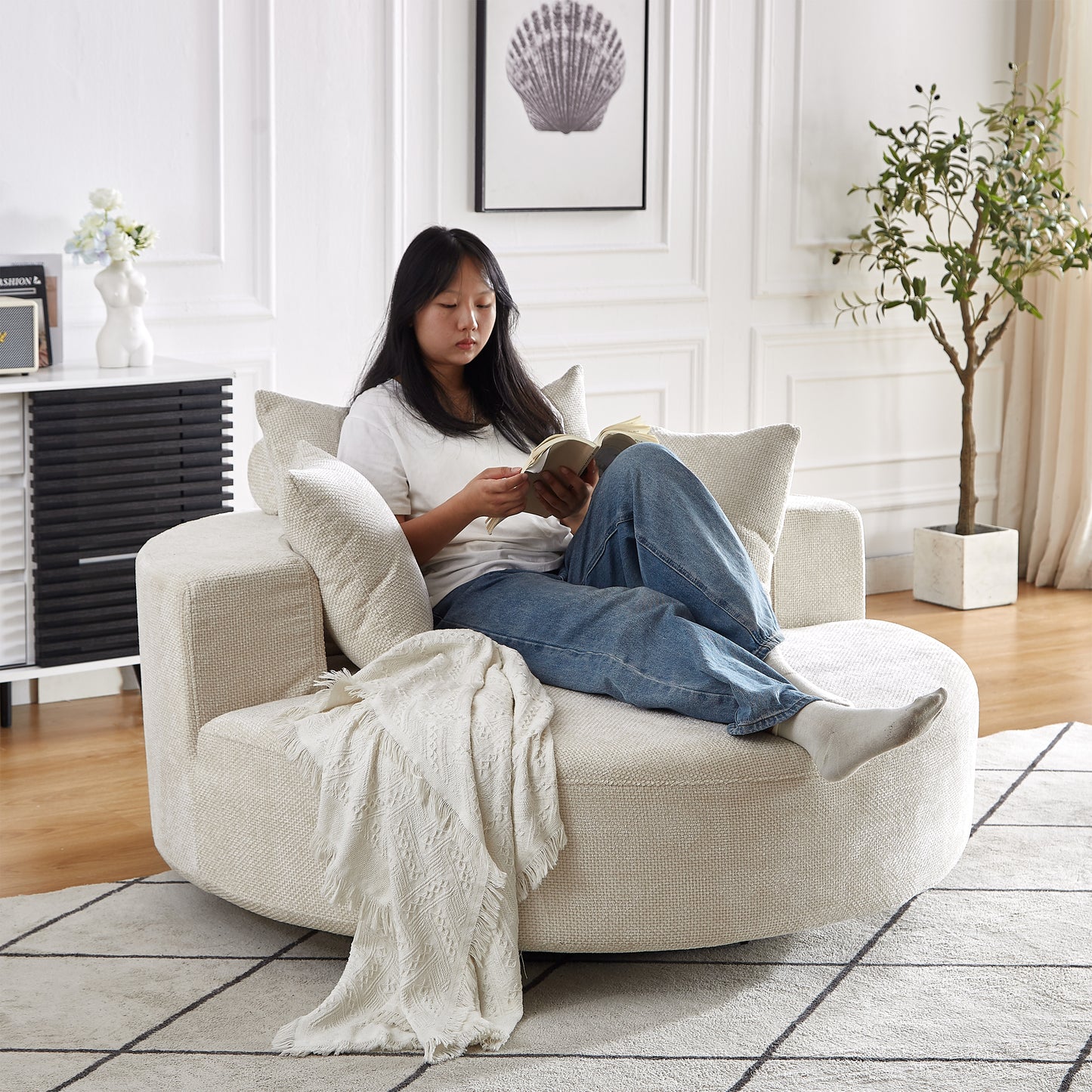 Textured cream swivel accent chair with plush cushions for comfortable reading
