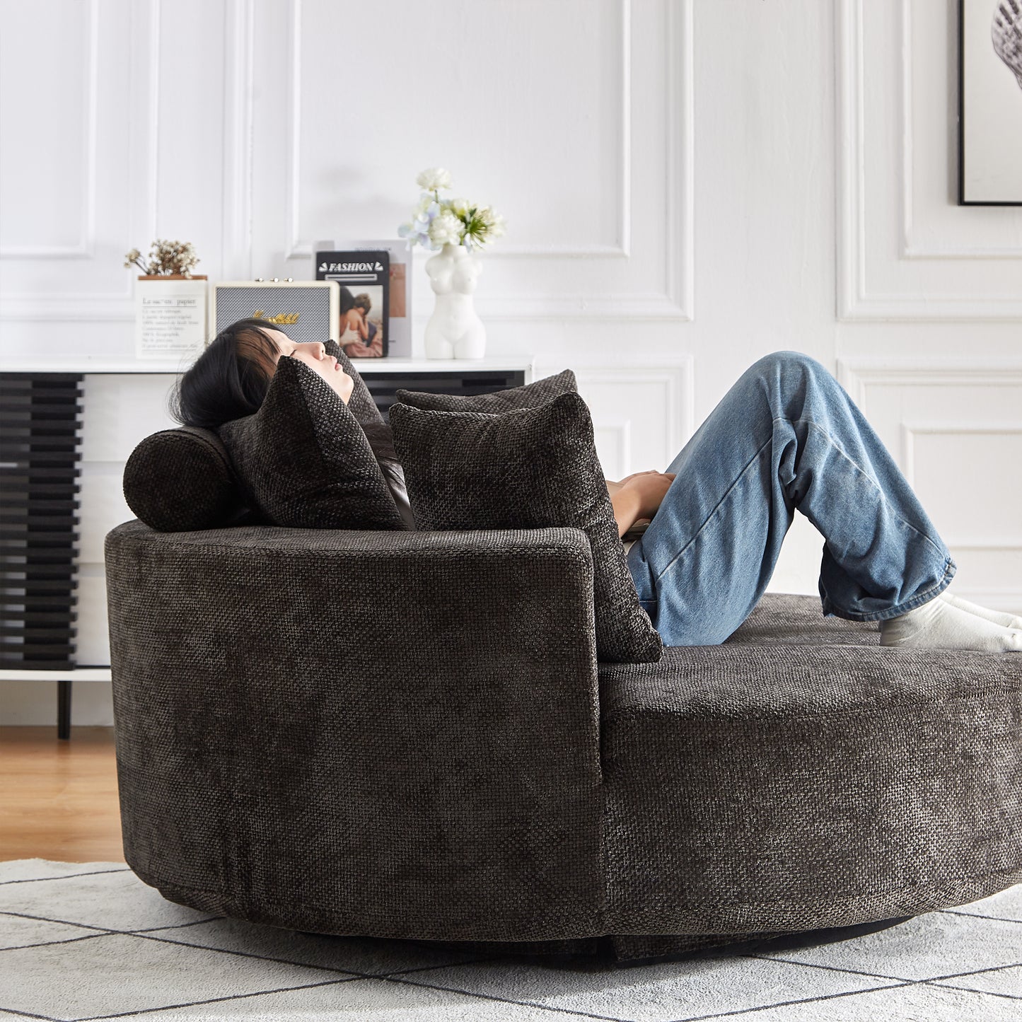 Dark grey textured fabric swivel chair with plush cushions ideal for relaxing