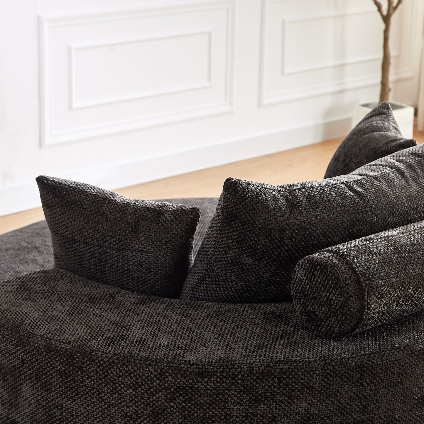 Textured charcoal grey fabric sofa with plush cushions and bolster pillows