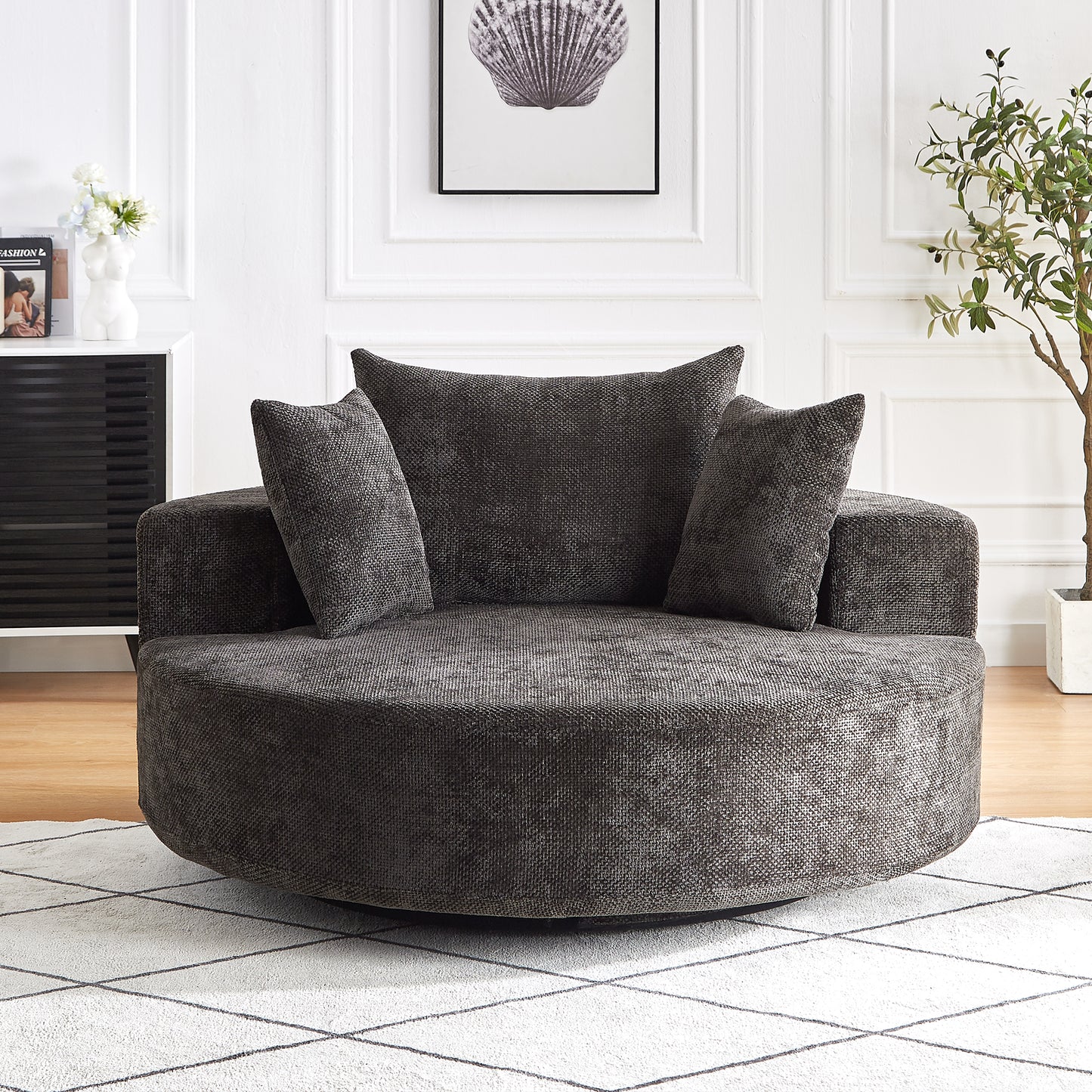 Dark grey circular swivel accent chair with textured fabric and plush cushions