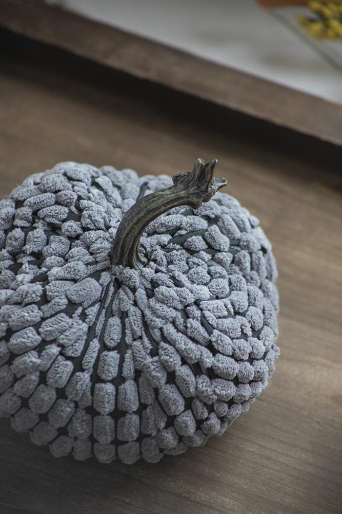 Textured gray faux pumpkin with dark stem ideal for autumn decor