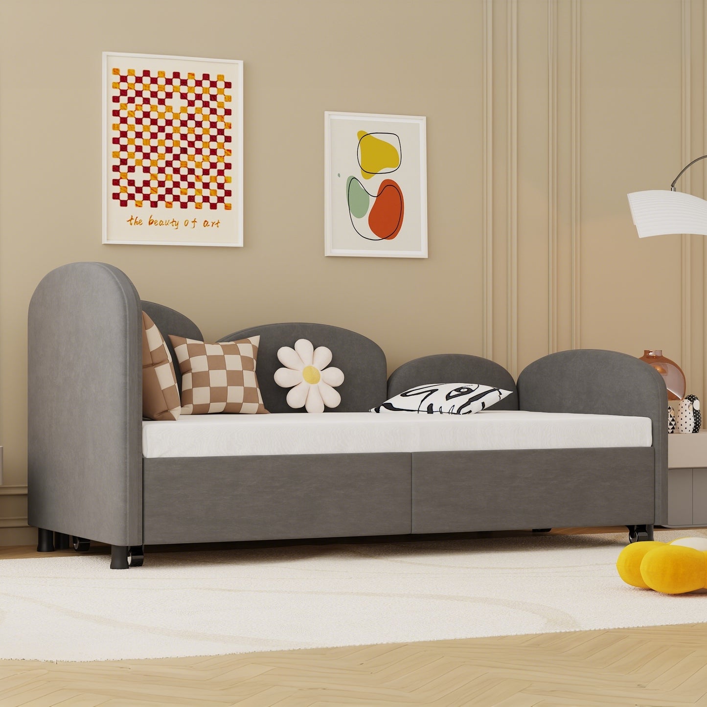 Grey upholstered daybed with rounded arms perfect for a childs bedroom